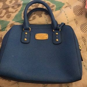 A blue Michael Kors purse